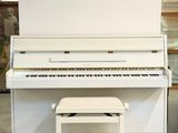 a white piano and a stool in a room