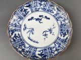 a blue and white plate with a bird on it