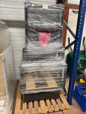 a stack of pallets in a warehouse with plastic wrap on them