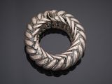 an image of a silver bracelet on a black surface