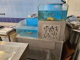 a fish tank in the middle of a kitchen with a sink