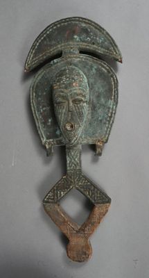 an old bronze head of a man with a helmet on it ' s head