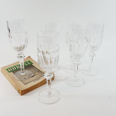 four wine glasses and a book on the table