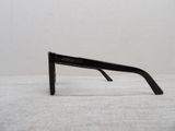 a pair of black glasses sitting on a white surface
