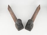 pair of antique wooden bookends with carved faces on them