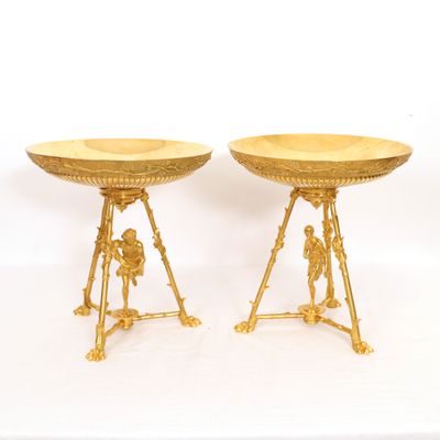 pair of gilded brass pedestals with figures on them