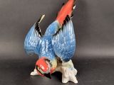 a figurine of a bird that is sitting on the ground
