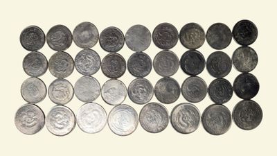 an image of a pile of coins sitting on top of a white surface