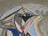 a painting on the wall of a building with a woman holding an umbrella