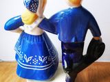 two figurines of a man and a woman on a table