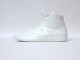 the white sneaker is on a white surface with a white background