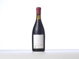 the bottle of wine is sitting on the table with a white background