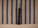a wooden object that is sitting on a shelf