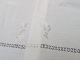 a white table cloth with a picture of a cat on it