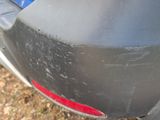 a close up of a car ' s rear bumper with a hole in it
