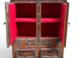 a wooden cabinet with two drawers and a red door