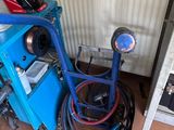 a blue machine that is sitting next to a wall