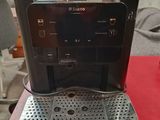 an espresso machine sitting on top of a red table
