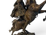 bronze statue of a man on a horse with a hat on his head