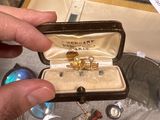 a person holding a ring in a box with a knife and fork