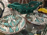 many plates and bowls on display in a glass case