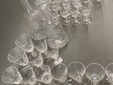 a lot of wine glasses and a decanter on the table