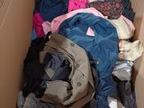 a cardboard box filled with clothes and clothing items