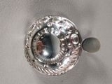 a close up of a silver plate with a mirror in it