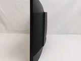a close up of a black computer monitor on a white surface