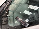 a sticker on the windshield of a car with a sticker on it