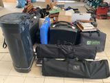 a pile of luggage sitting on the floor next to a trash can