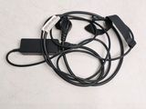 a black cord that is connected to a charger on a table