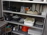 many pots and pans on the shelves in the kitchen