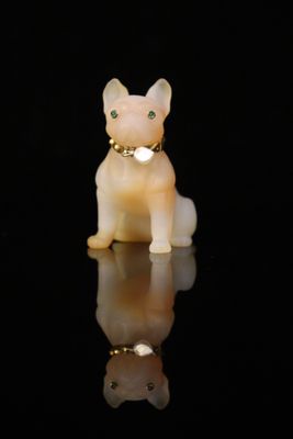 an image of a cat figurine sitting on a reflective surface