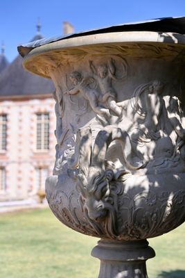 a large vase sitting in the middle of a field