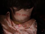 a close up of a doll ' s neck with a tattoo on it