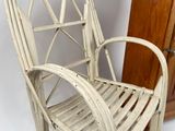 a white wicker chair next to a wooden cabinet