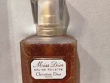 christian dior miss dior eau de toilette spray in a glass bottle on a white surface