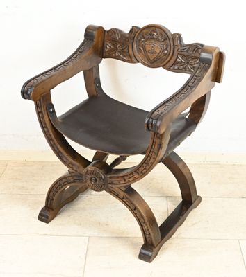 an image of a wooden chair with a leather seat on a tile floor