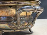 a metal bowl with a handle on a table
