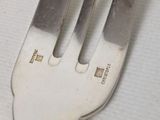 a fork that has a piece of silver on it