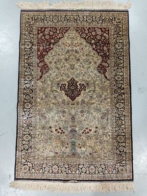 a beige and red rug with a medallion design on it