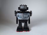 un robot jouet posé sur une surface blanche