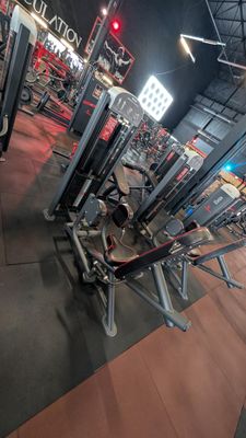 a gym with a lot of machines in it