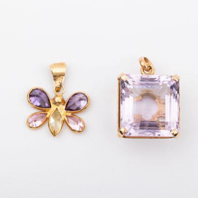 two amethorate and amethorate pendants on a white background
