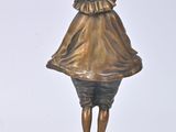 bronze figurine of a boy with a bird on his head