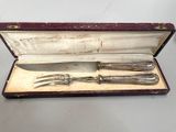 a silverware set in a red case on a table