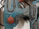 two electric tools that are sitting on a table