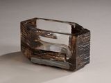 a glass ashtray that is sitting on top of a table