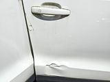 a close up of a car door with a hole in it